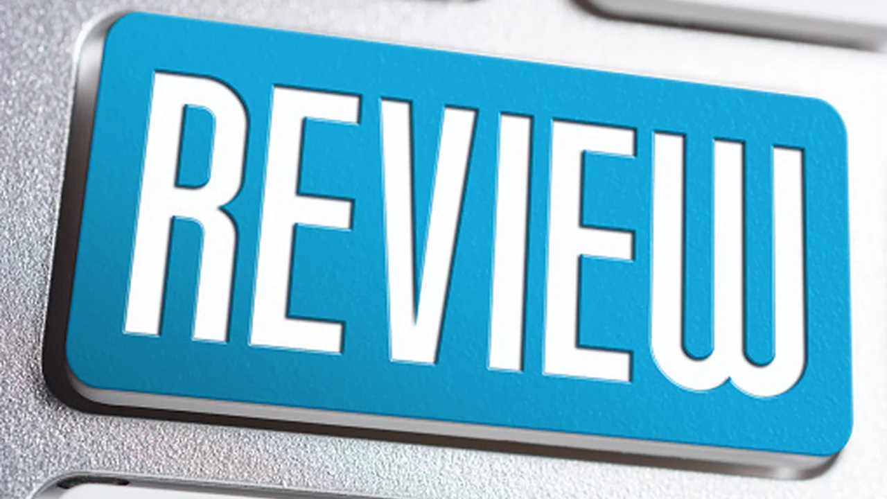 Close up on a plate of mashed potatoes, topped with baked pork chops with cream of mushroom soup, and a side of green beans.