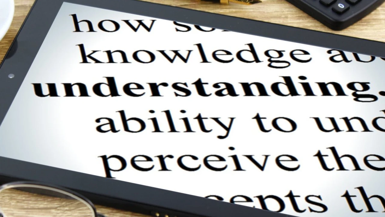 Close up on a plate of mashed potatoes, topped with baked pork chops with cream of mushroom soup, and a side of green beans.